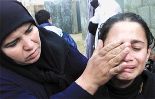 The sister of Jawad Zaidan (16) crying. He was killed inside his own home in Khan Younis, Gaza Strip, when his home was hit by a shell from an Israeli occupation tank (Alquds, 12/19/02). 