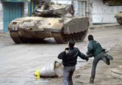 Palestinian boys resisting Israeli occupation tanks with stones (Tishrin, 2/20/03).