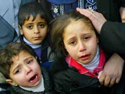Palestinian children crying in the funeral of their father, who was killed by Israeli occupation forces  (Tishrin, 2/9/03).