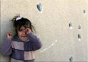 One of the daughters of slain Palestinian woman Nahla Aqel cries on Monday in front of a bullet-scarred wall at the spot where her mother was machine-gunned the day before by an Israeli tank in the southern Gaza Strip refugee camp of Rafah. (Arab News, 12/10/02