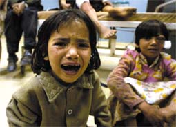 Two injured Iraqi girls, whose parents were killed during a US air raid on Baghdad, devastated after looters took the beds they were sleeping on, in the hospital (Alquds, 4/12/03).