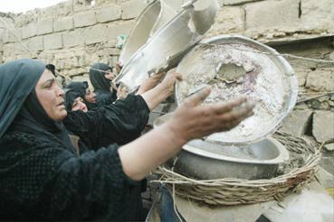Iraqi women begging for food to feed their children. (Alq. Ala, 4/1/03 