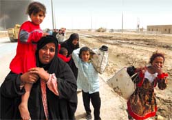 An Iraqi mother and her children were forced to abandon their home outside Basra because of the fighting between defenders of the city and the US-UK forces (Alquds, 4/1/03). 